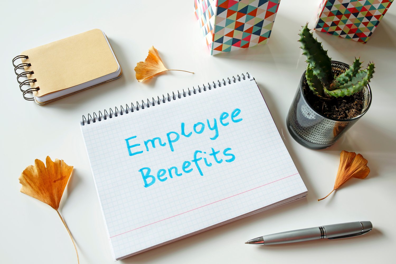 employee benefits written in notebook on white table